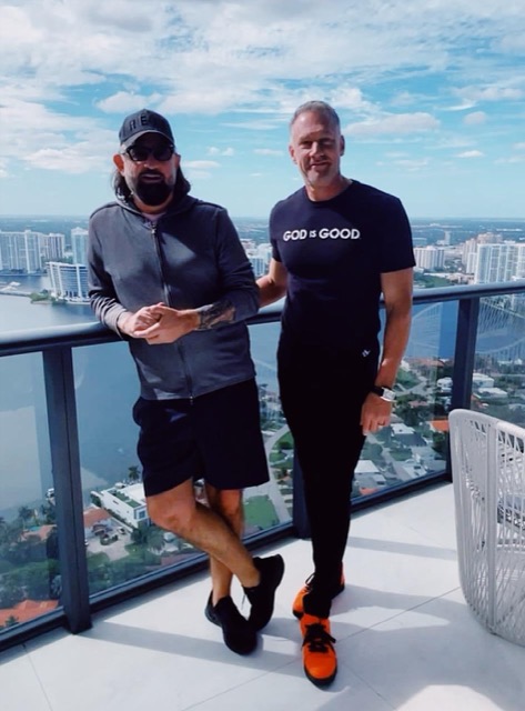 Terry Fisher with Gary Brecka on a balcony above the Miami skyline