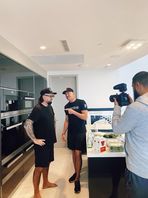 Terry Fisher and Gary Brecka being filmed in a kitchen