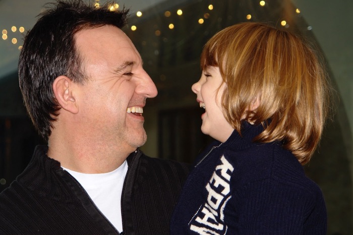 A younger Terry Fisher laughing with Harry as a small boy